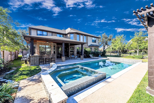 view of swimming pool with a patio area and an in ground hot tub