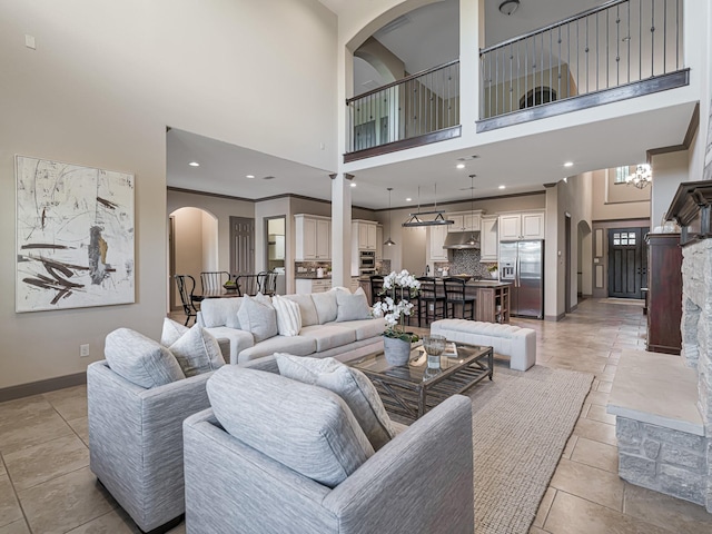 living room featuring light tile patterned flooring and a towering ceiling