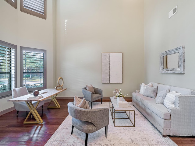 living room featuring hardwood / wood-style flooring and a high ceiling