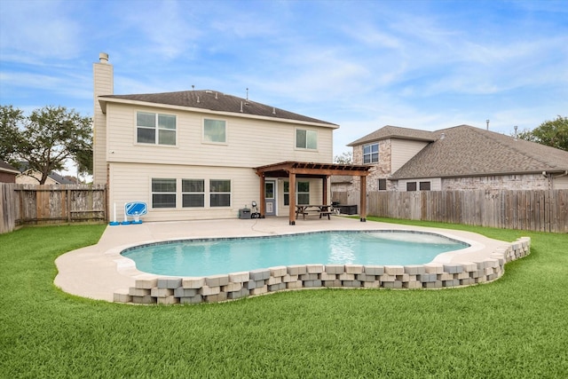 rear view of property featuring a fenced in pool, a yard, and a patio