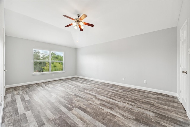 spare room with lofted ceiling, dark wood-type flooring, and ceiling fan