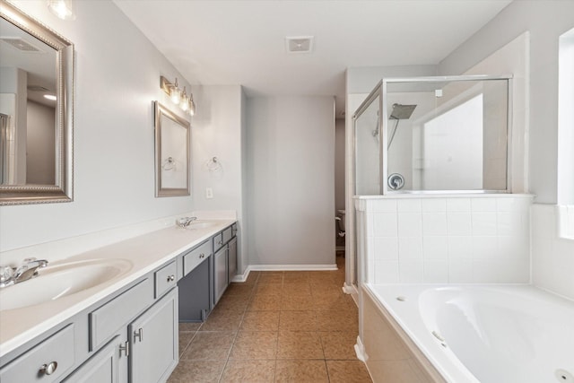 bathroom featuring independent shower and bath, vanity, and tile patterned flooring