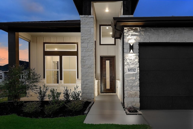 exterior entry at dusk with a garage