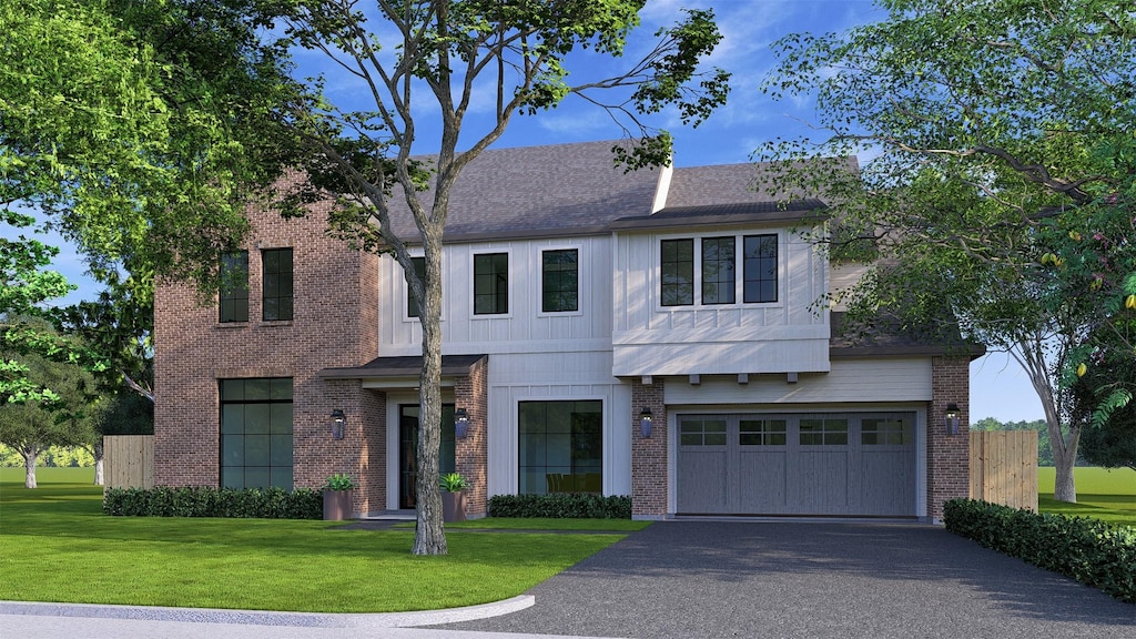 view of front of property featuring a garage and a front lawn