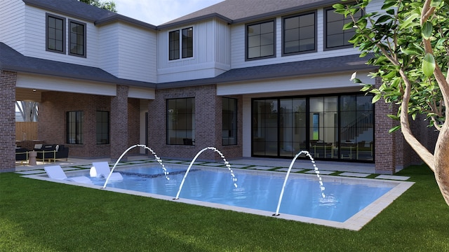 view of swimming pool featuring pool water feature and a yard