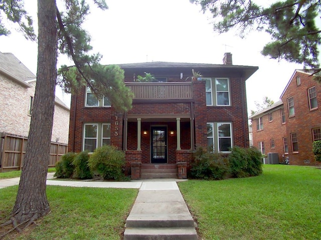 view of front of property with a balcony, central air condition unit, and a front lawn