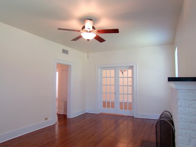 unfurnished living room with dark wood-type flooring, french doors, ceiling fan, and plenty of natural light