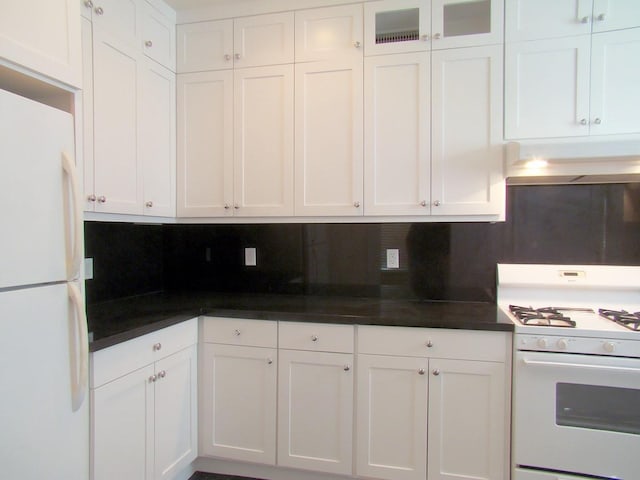 kitchen featuring white appliances, decorative backsplash, and white cabinets