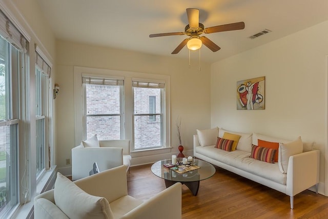 living room with plenty of natural light, hardwood / wood-style floors, and ceiling fan