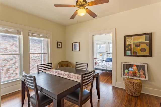 dining area with ceiling fan and dark hardwood / wood-style flooring