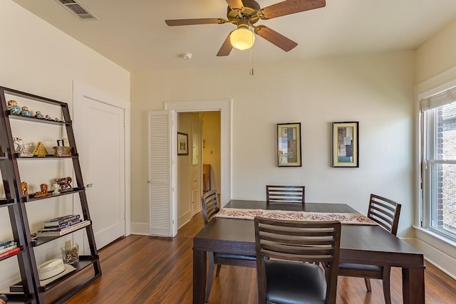 dining space with ceiling fan and dark hardwood / wood-style floors