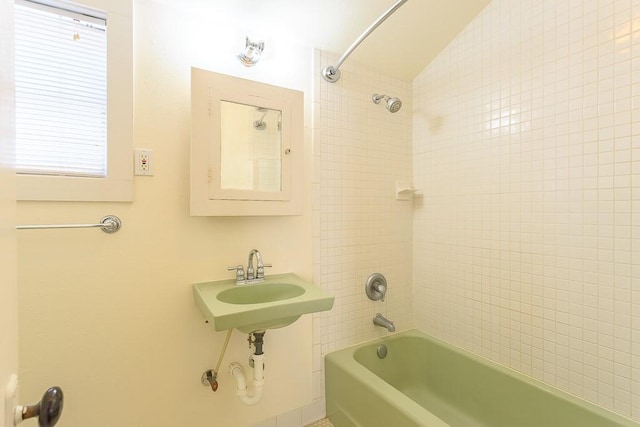 bathroom featuring shower / bath combination and sink