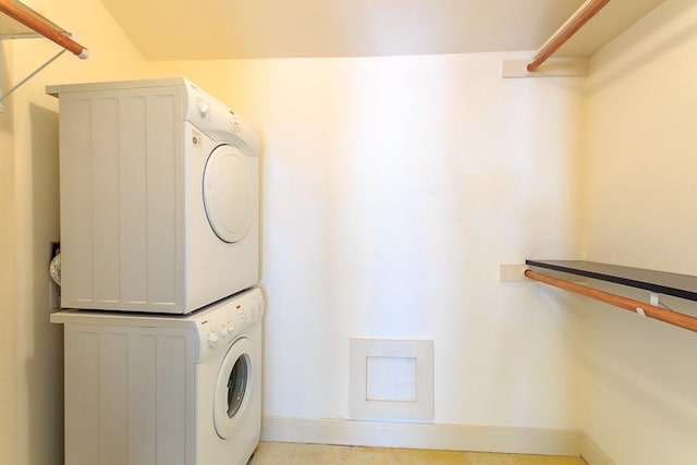 washroom featuring stacked washer and dryer