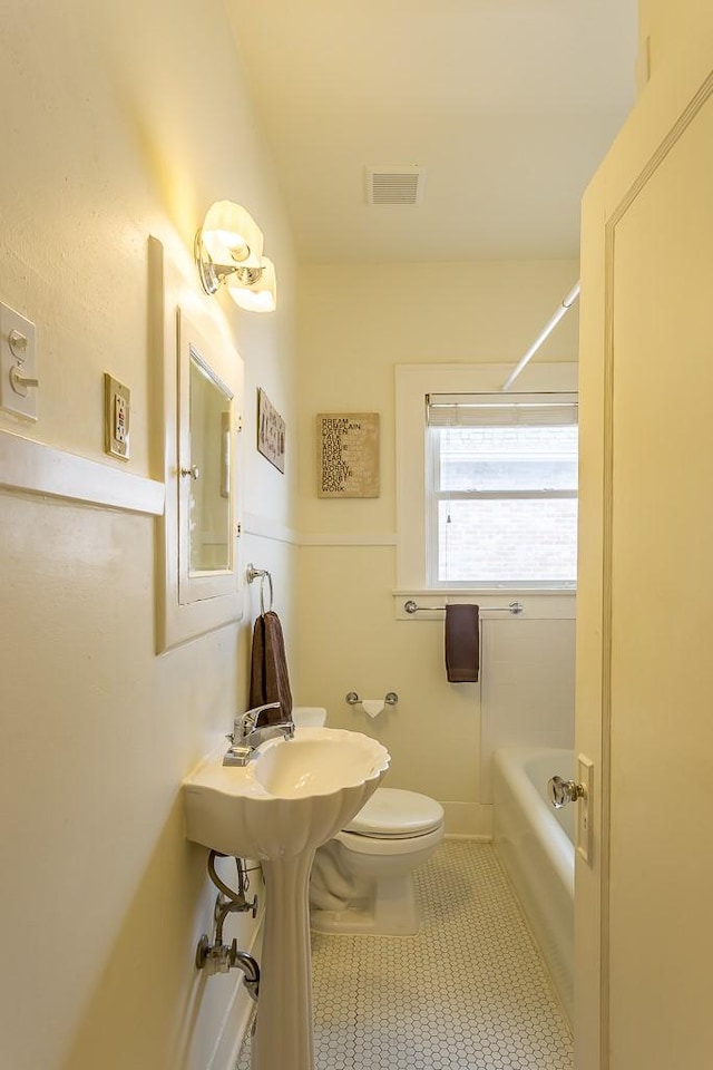 bathroom with tile patterned flooring, plus walk in shower, and toilet