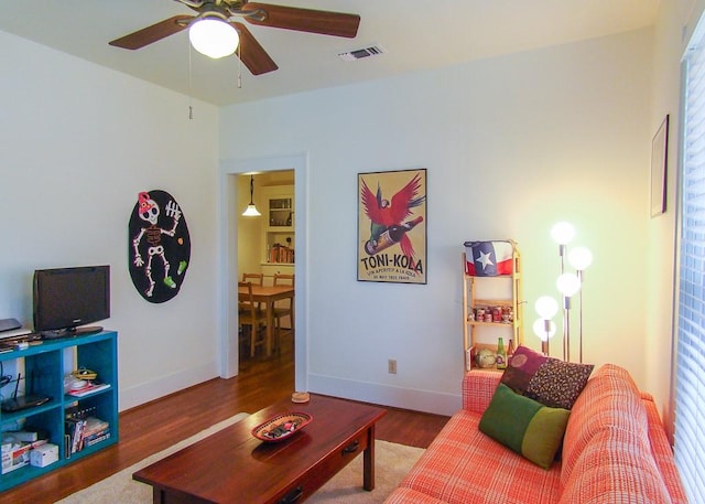 living room with ceiling fan and hardwood / wood-style floors