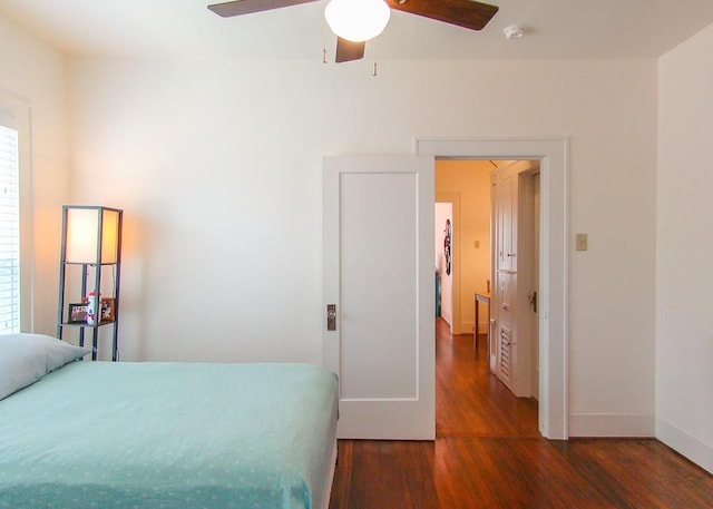 bedroom featuring ceiling fan and dark hardwood / wood-style flooring