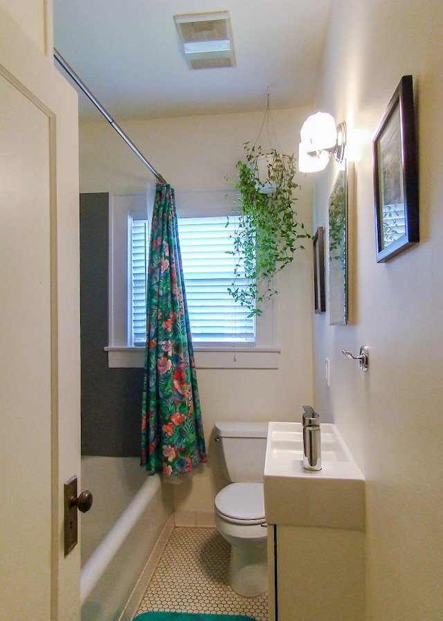 full bathroom featuring vanity, tile patterned floors, toilet, and shower / bath combo