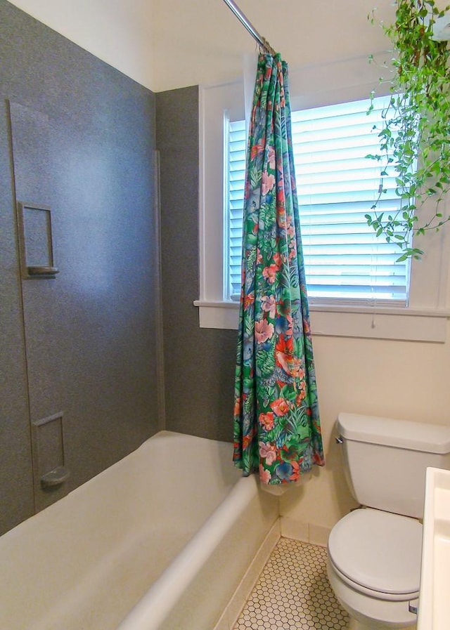 bathroom featuring shower / tub combo with curtain, tile patterned floors, and toilet