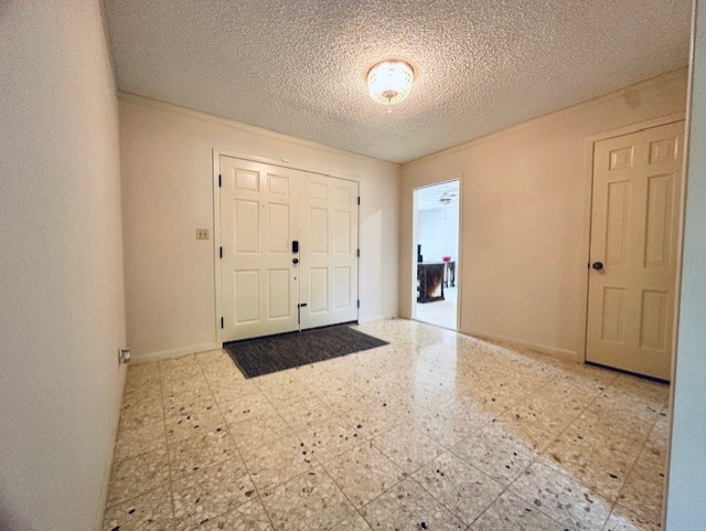 foyer entrance with a textured ceiling