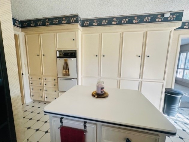 kitchen with double oven and cream cabinets