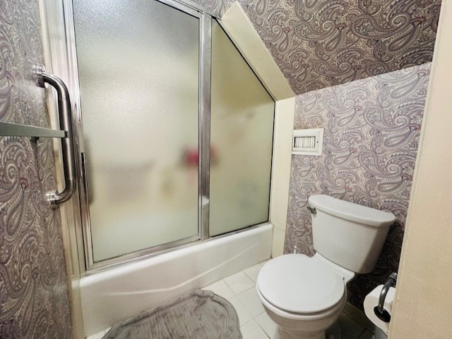 full bathroom with enclosed tub / shower combo, tile patterned flooring, and toilet