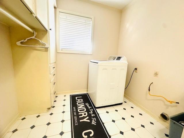 washroom featuring washer / dryer, baseboards, and light floors