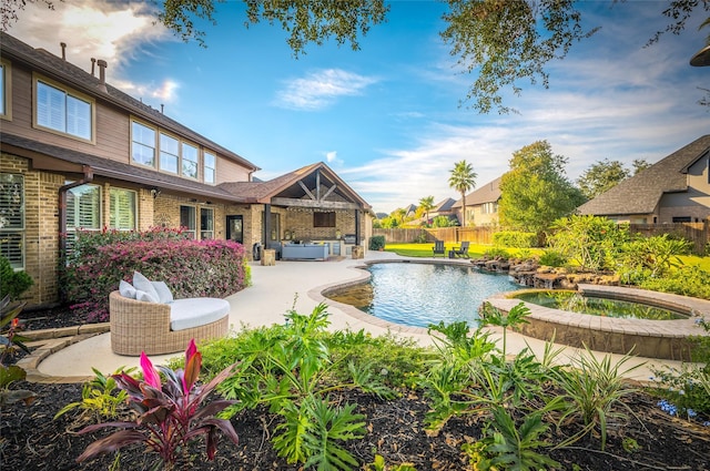 view of swimming pool with an in ground hot tub and a patio area