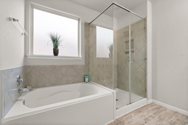 bathroom with wood-type flooring and separate shower and tub