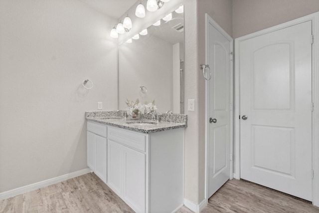 bathroom with hardwood / wood-style flooring and vanity