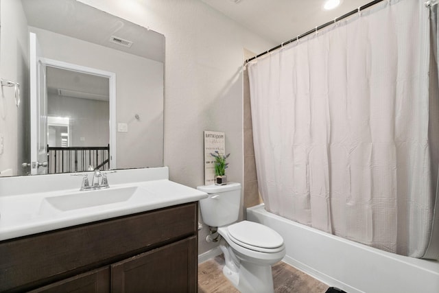 full bathroom with vanity, hardwood / wood-style floors, toilet, and shower / bathtub combination with curtain