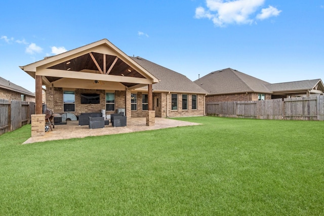 rear view of house with an outdoor living space, a yard, and a patio area