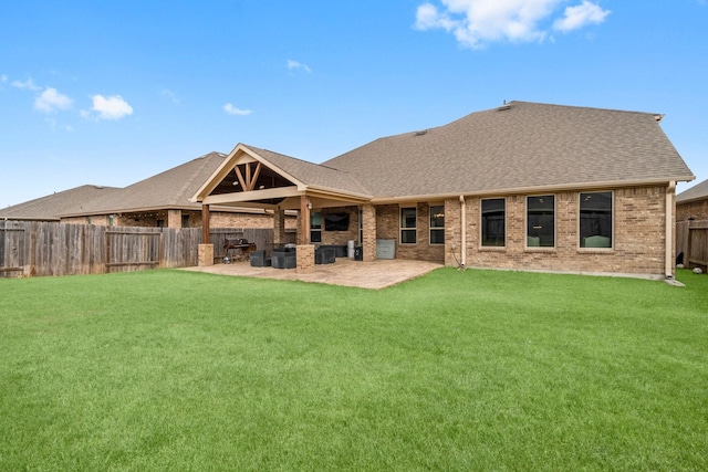 rear view of property featuring a yard and a patio area