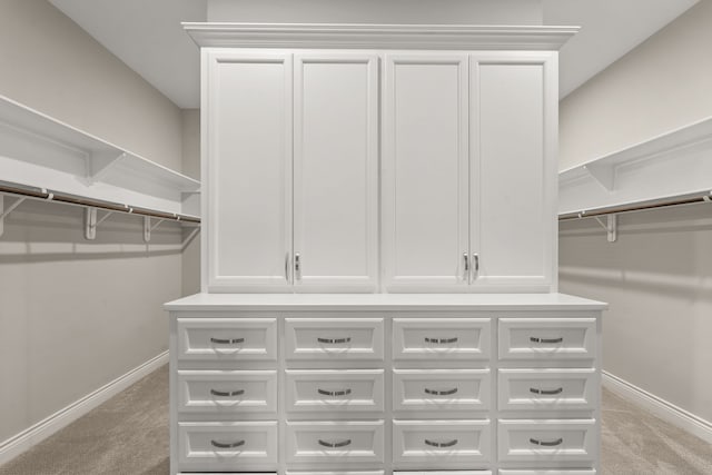 spacious closet featuring light carpet