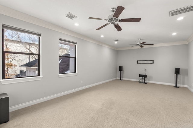 empty room with crown molding and light carpet