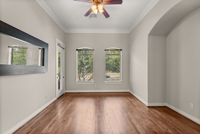 spare room featuring hardwood / wood-style flooring, ornamental molding, and ceiling fan