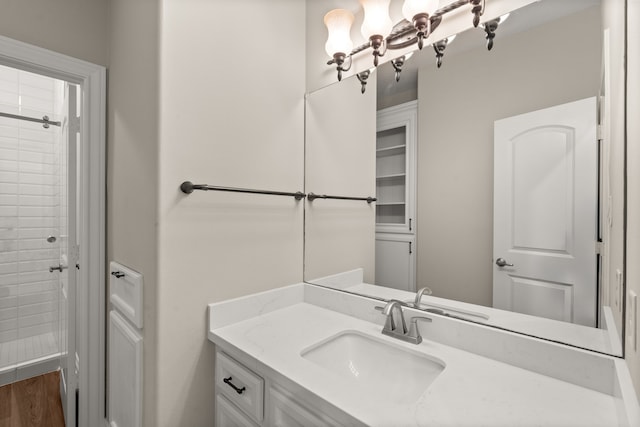 bathroom featuring vanity, hardwood / wood-style floors, and walk in shower