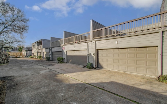 exterior space featuring a garage and a balcony