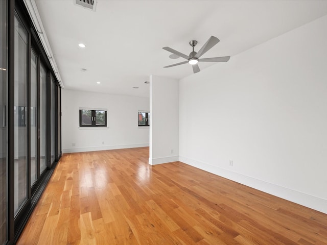 spare room with recessed lighting, visible vents, a ceiling fan, light wood-type flooring, and baseboards