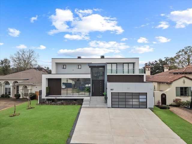 view of front of house featuring driveway, a front lawn, and stucco siding