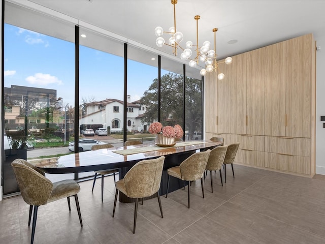 dining area with a wall of windows and an inviting chandelier