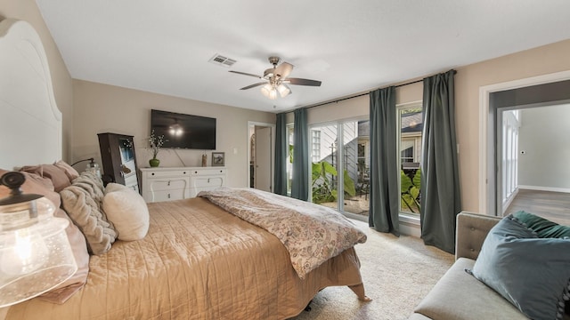 bedroom with light colored carpet, access to exterior, and ceiling fan