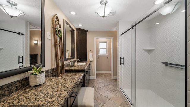 bathroom featuring vanity and a shower with door