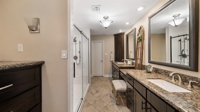 bathroom featuring vanity and an enclosed shower