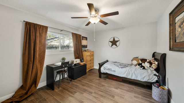 bedroom featuring hardwood / wood-style flooring, a textured ceiling, and ceiling fan