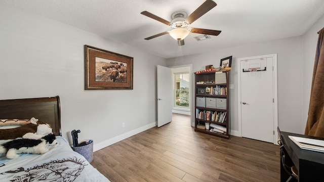 bedroom featuring ceiling fan and dark hardwood / wood-style flooring