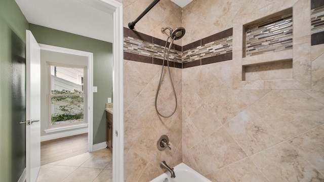 bathroom featuring tile patterned flooring and tiled shower / bath