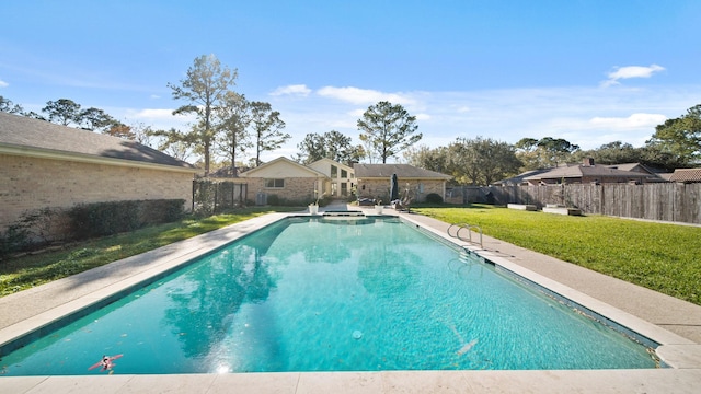 view of swimming pool featuring a lawn