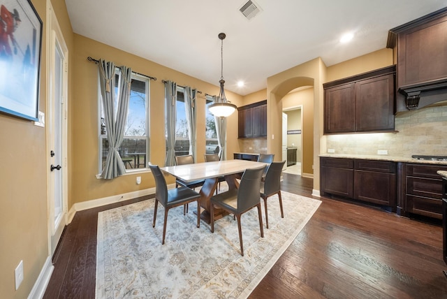 dining space with dark hardwood / wood-style floors