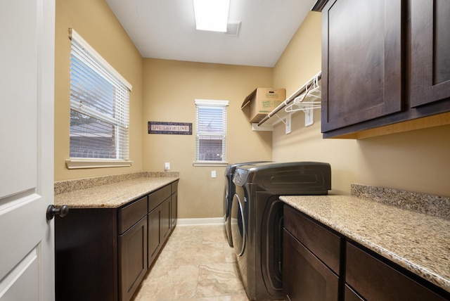 washroom with cabinets, separate washer and dryer, and a wealth of natural light