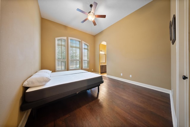 bedroom with dark wood-type flooring, connected bathroom, and ceiling fan